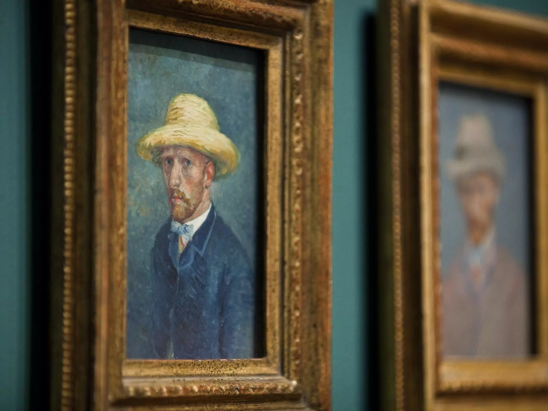 Two framed self-portraits of Vincent Van Gogh, hanging on the wall in the Van Gogh Museum, Amsterdam.