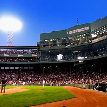 People watching a baseball game in a stadium