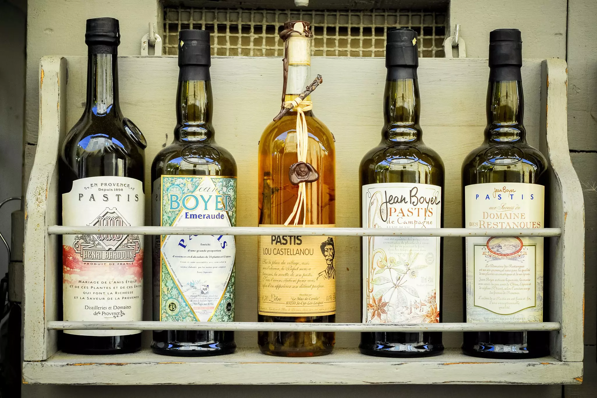 Bottles of Pastis in a tow. A typical aniseed liqueur -- a fresh and refreshing aperitif accompanied by salads and olives. 