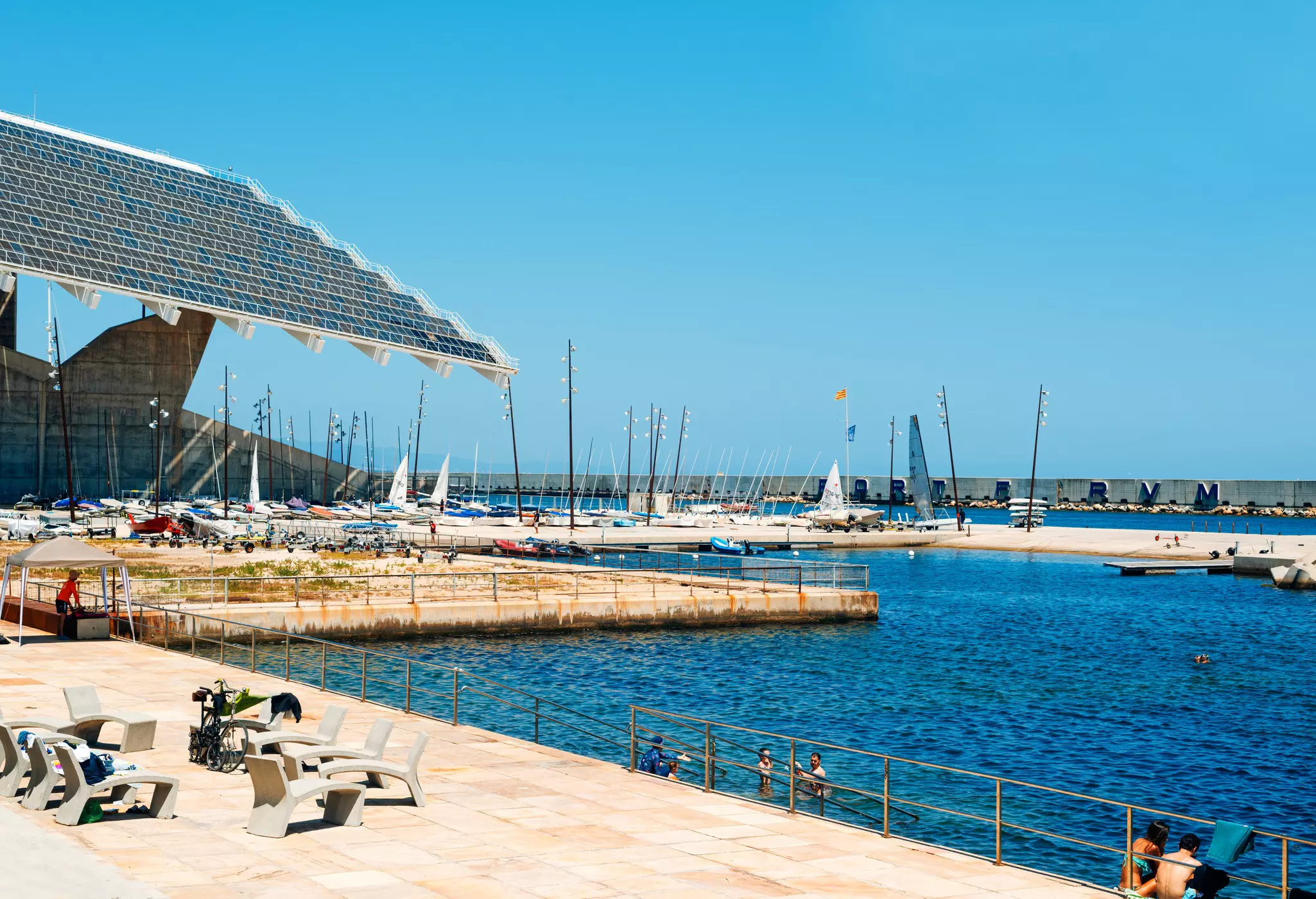 People swimming in the sea at Parc del Fòrum in Barcelona, Spain