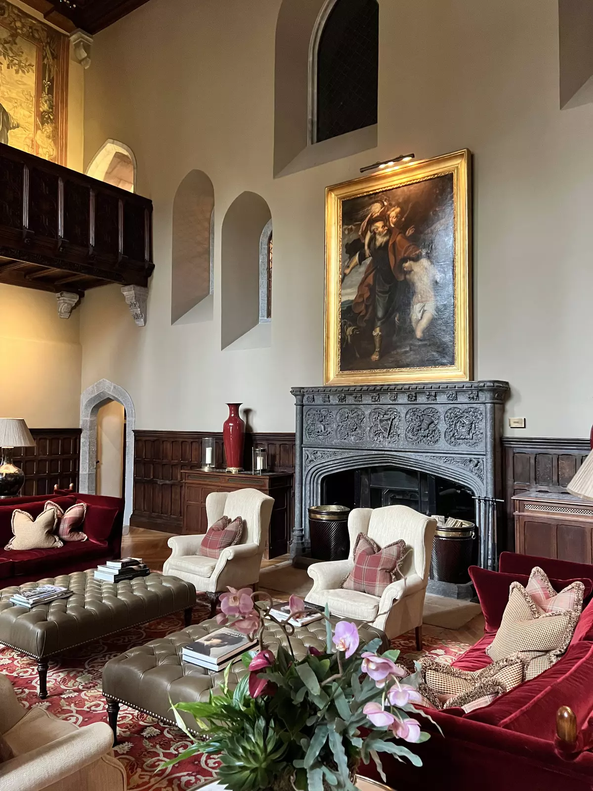 The lobby of a grand luxury hotel, with comfortable seating and a large fireplace.