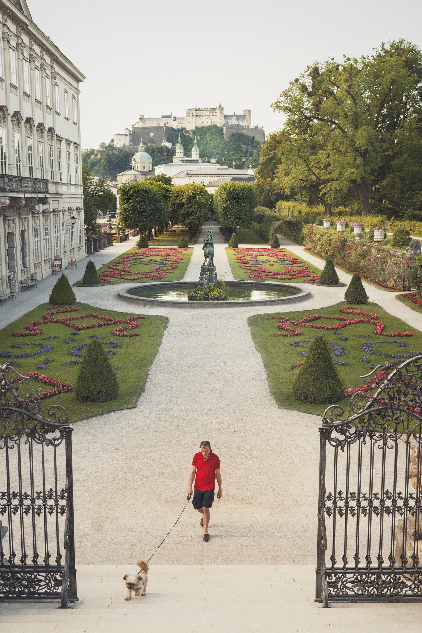 austria, europe, jonathan stokes, jonathan stokes photography, luxury, photograhpy, photography, salzburg, tourism, travel, austria europe jonathan stokes jonathan stokes photography luxury photograhpy photography salzburg tourism travel
Man walks his dog through the gardens at Mirabell Palace (Schloss Mirabell).