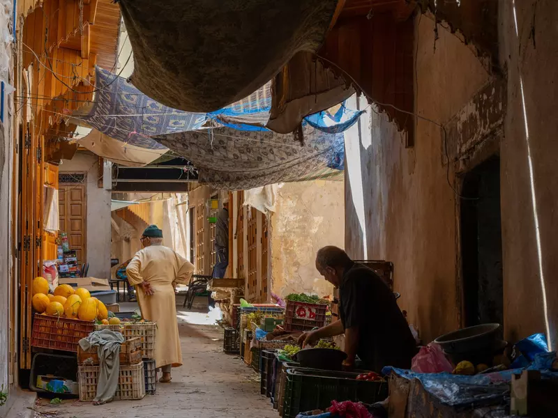 People stand in a market medina in Fez, Morocco. 
