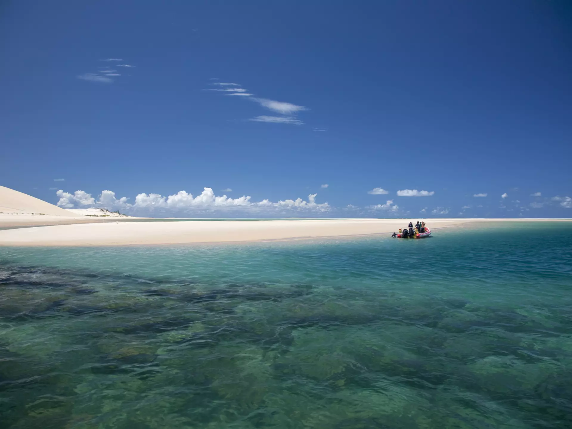 Mozambique, Bazaruto Archipelago. Divers kit up on a zodiac, ready to explore the stunning coral reefs off Benguerra Island.