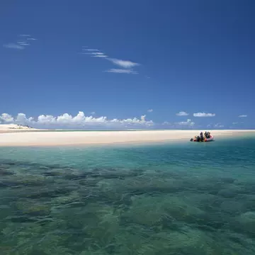 Mozambique, Bazaruto Archipelago. Divers kit up on a zodiac, ready to explore the stunning coral reefs off Benguerra Island.