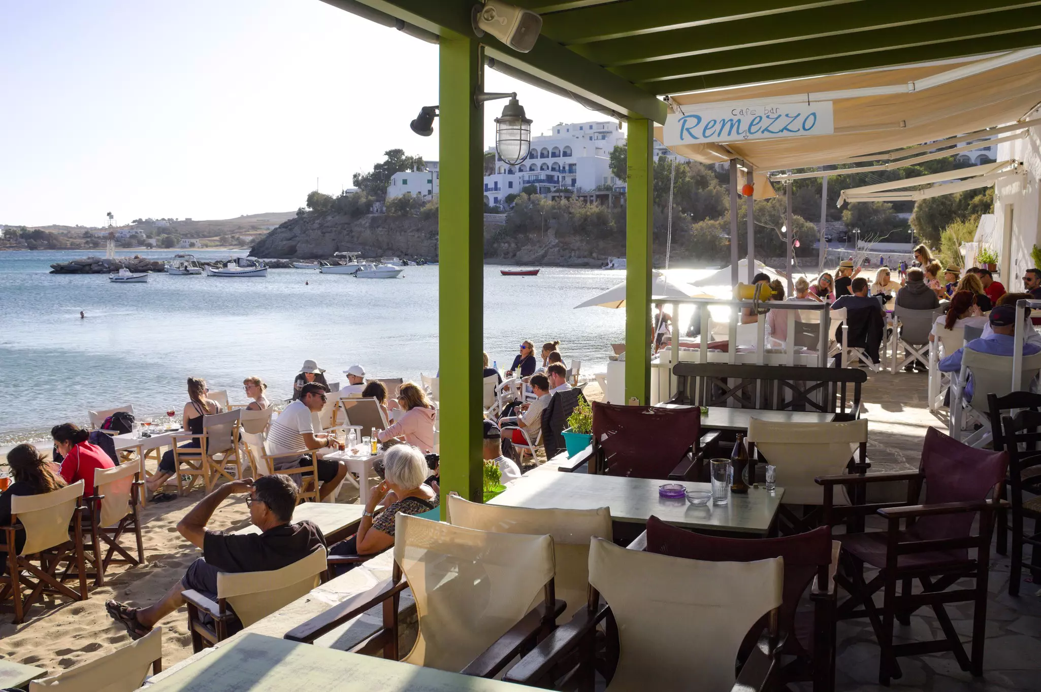 Holidaymakers relax at a beach bar in the small village of Piso Livadi © Shutterstock / Thirasia