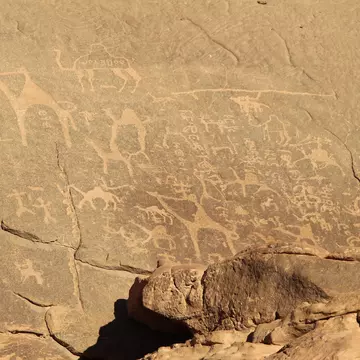 Jordan, Wadi Rum village - January 06, 2020: Petroglyphs (Alameleh inscriptions) of a caravan of camels on the sandstone rock in Wadi Rum desert in Jordan.; Shutterstock ID 1638494605;