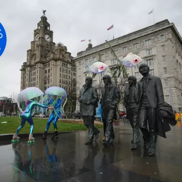 Roller skaters get into the Eurovision spirit next to the famous statue of the Beatles by the Liverpool waterfront © Peter Byrne / PA Images via Getty Images