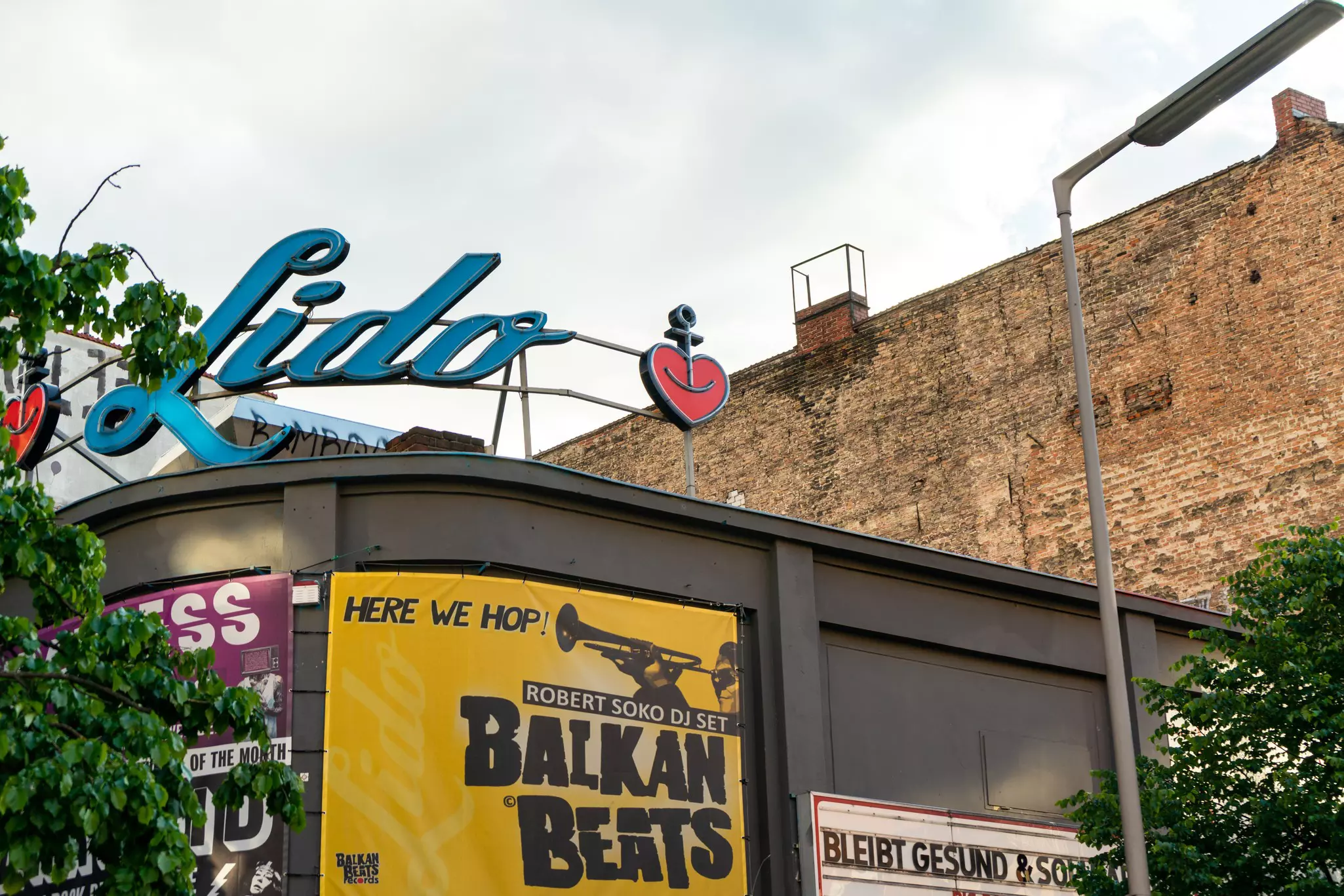 The exterior of a nightclub with a large sign above it that reads "Lido"