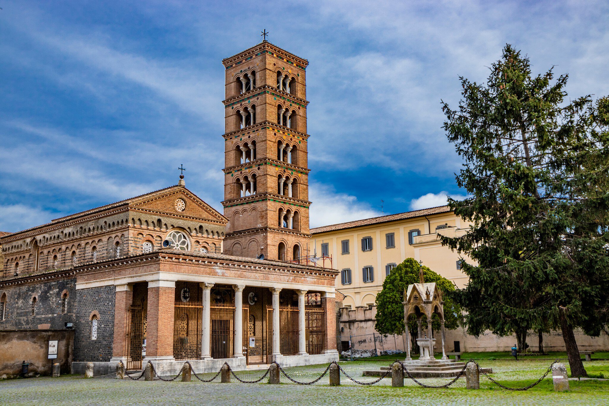 The church, the bell tower, and the liturgical fountain "the Paradise" in the Exarchic Monastery of Saint Mary in Grottaferrata, Greek Abbey of Saint Nilus, the last Byzantine-Greek monastery in Italy; Shutterstock ID 1249634503;