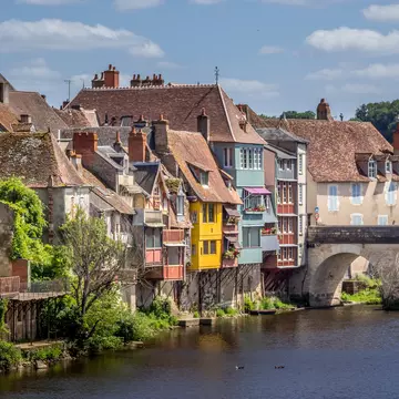 Brightly colored half-timbered houses overhanging a river in Argenton-sur-Creuse, France
