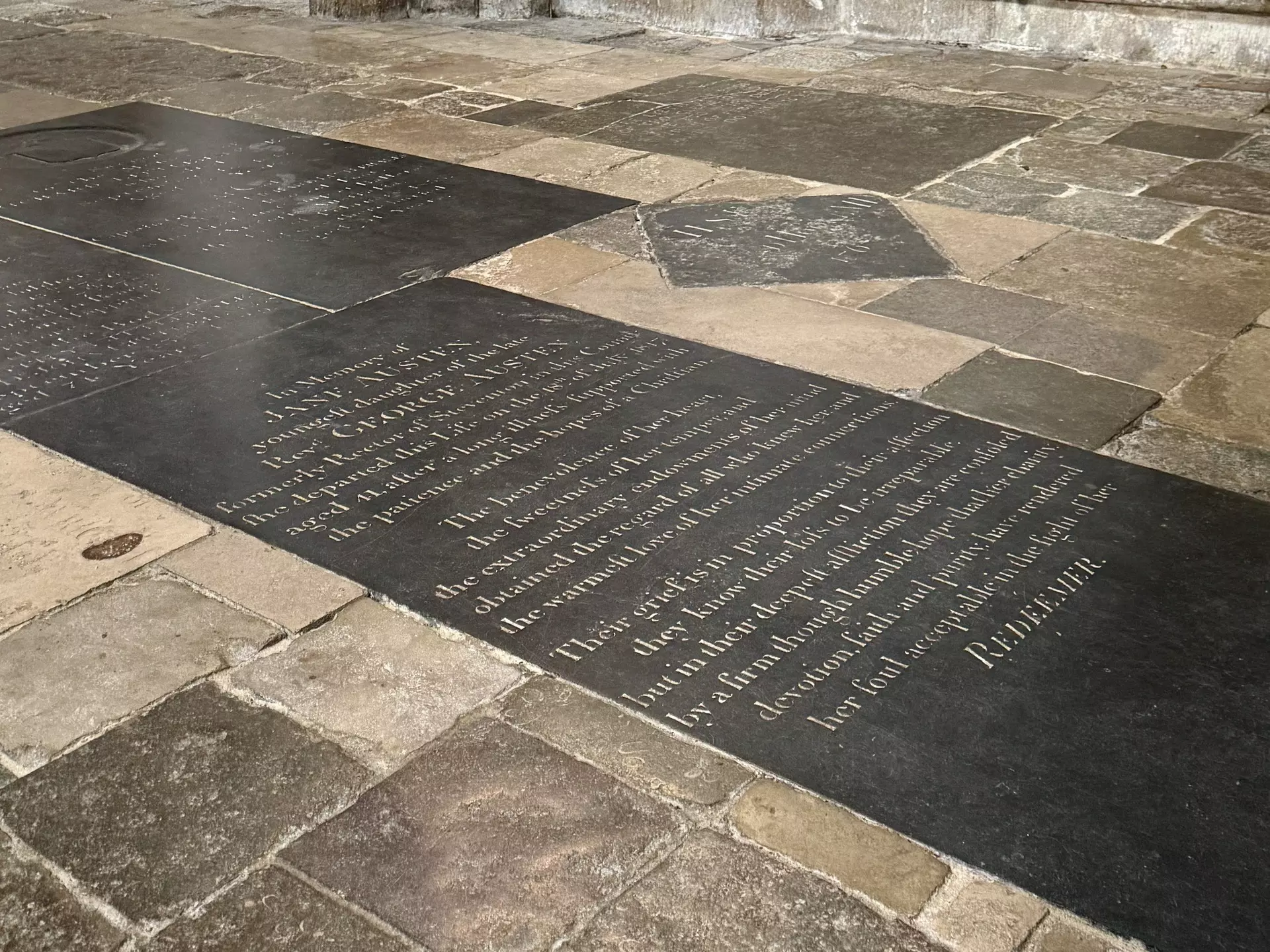 A stone floor panel with writing inscribed on it.