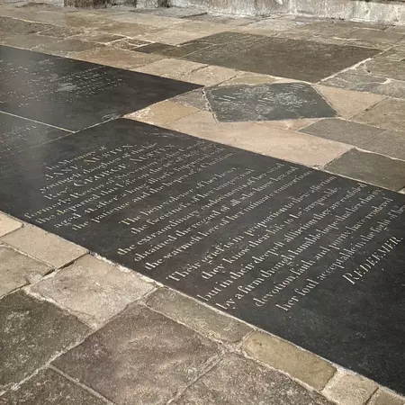 A stone floor panel with writing inscribed on it.