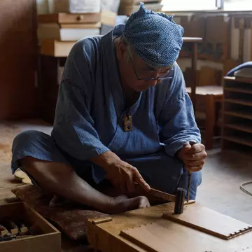 A Japanese artisan uses traditional woodworking methods. Courtesy of Wabunka