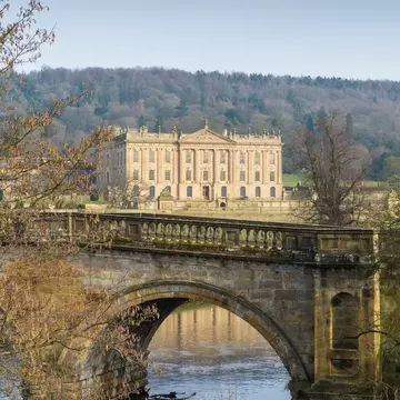 MARCH 15, 2016: Chatsworth House reflected in a lake in Derbyshire.