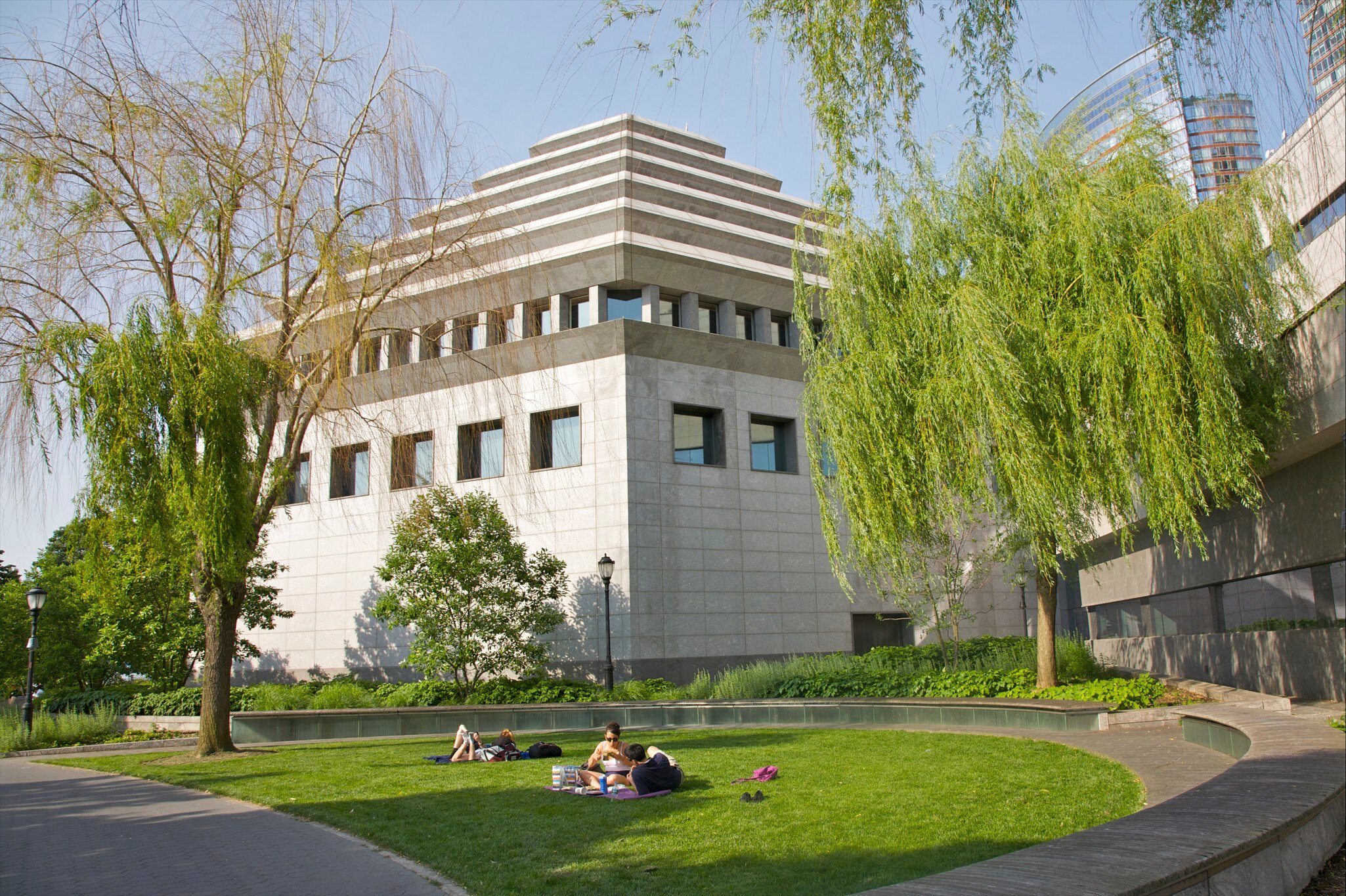 People on lawn near ziggurat building