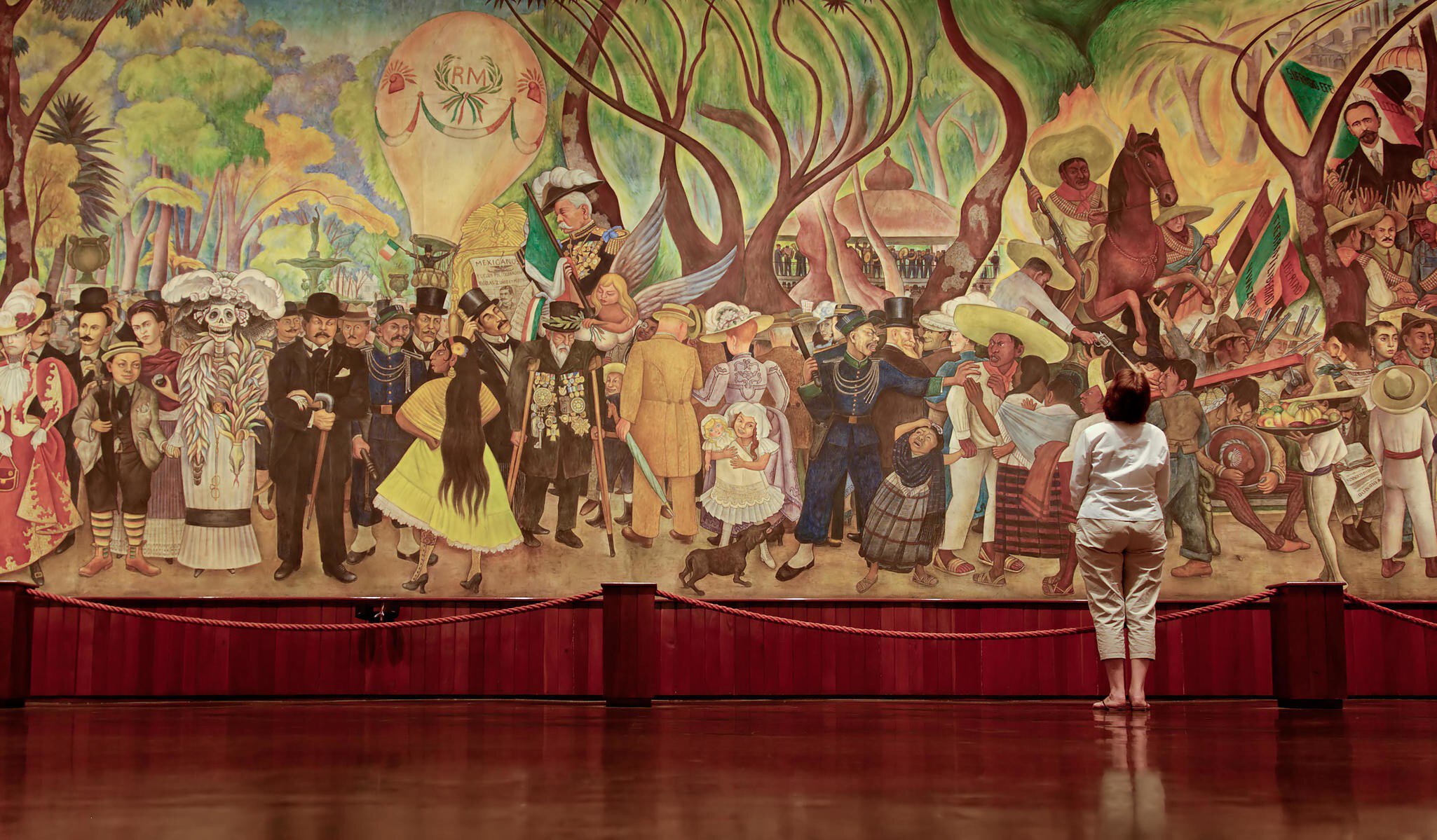A woman views Rivera's mural entitled, 'A Dream of a Sunday Afternoon in Alameda Park', in the Diego Rivera Mural Museum.