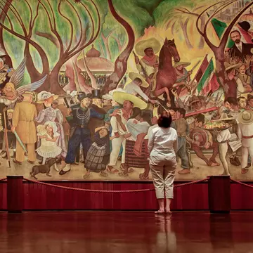 A woman views Rivera's mural entitled, 'A Dream of a Sunday Afternoon in Alameda Park', in the Diego Rivera Mural Museum.
