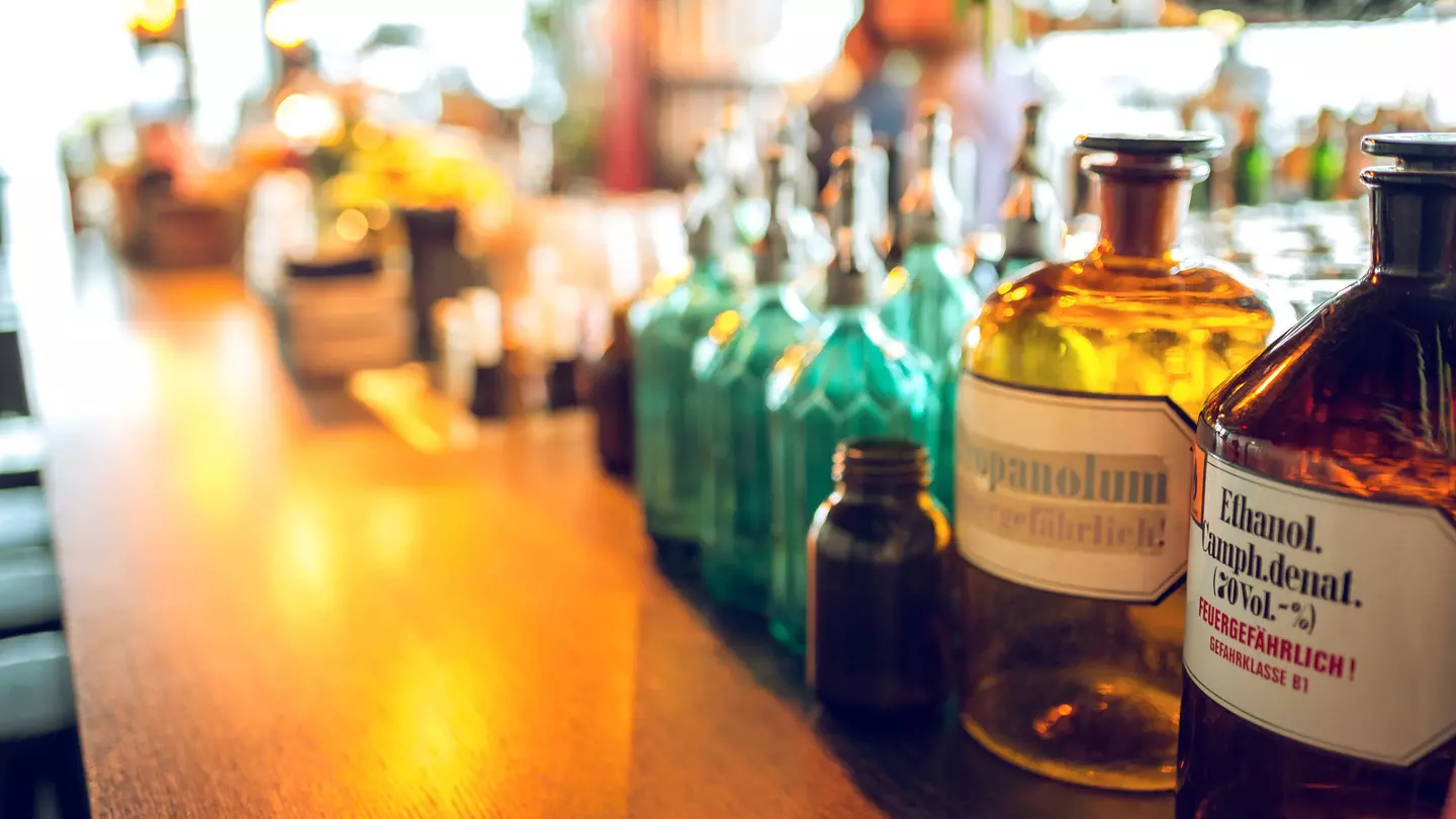 A red topped waiter serves a Satan white beer from the 'De Block' breewery in the pub 'Family Brews' in the Rue des Harengs in Brussels, Belgium.