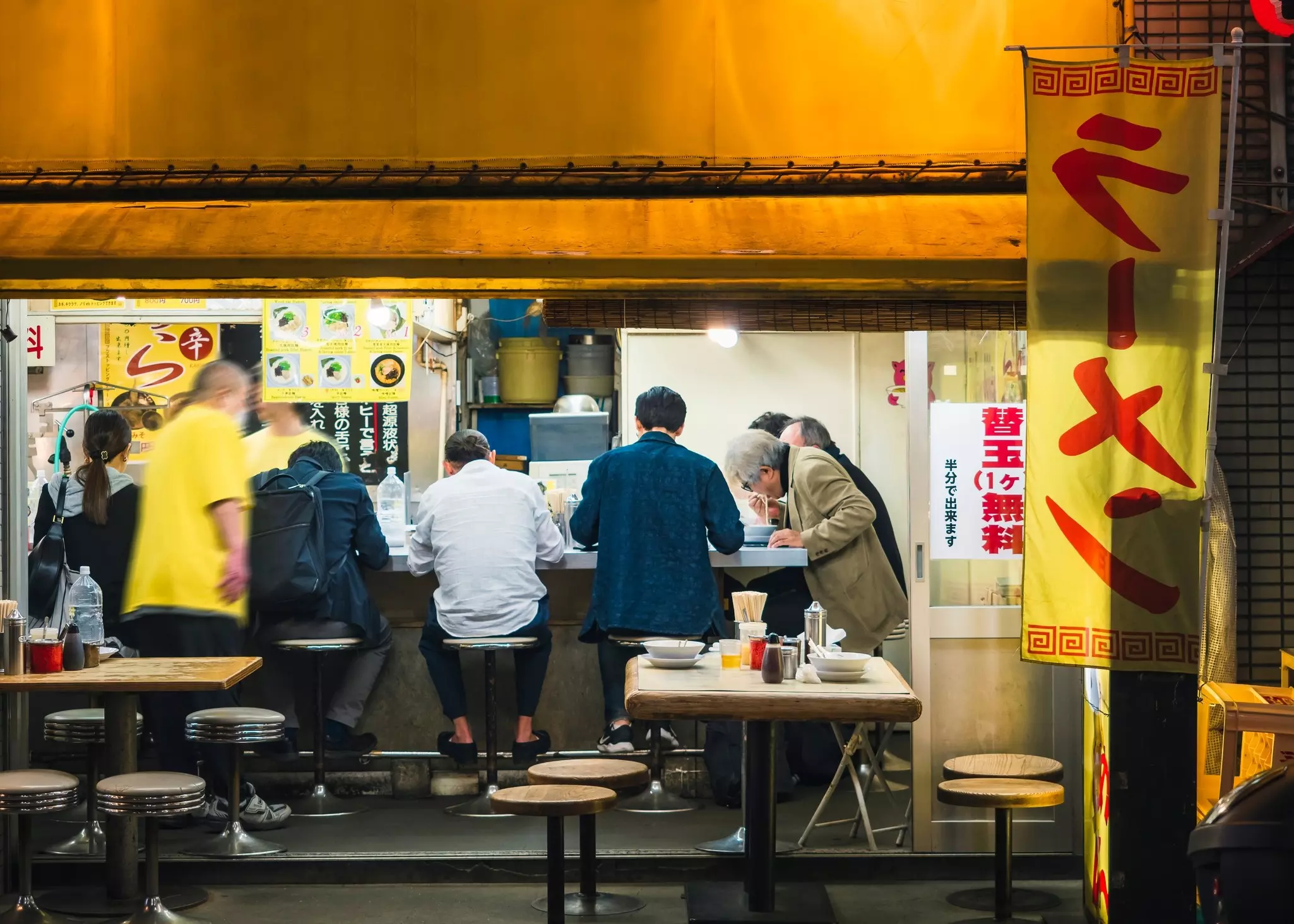 A full counter of diners at a Tokyo ramen shop. VTT Studio/Shutterstock