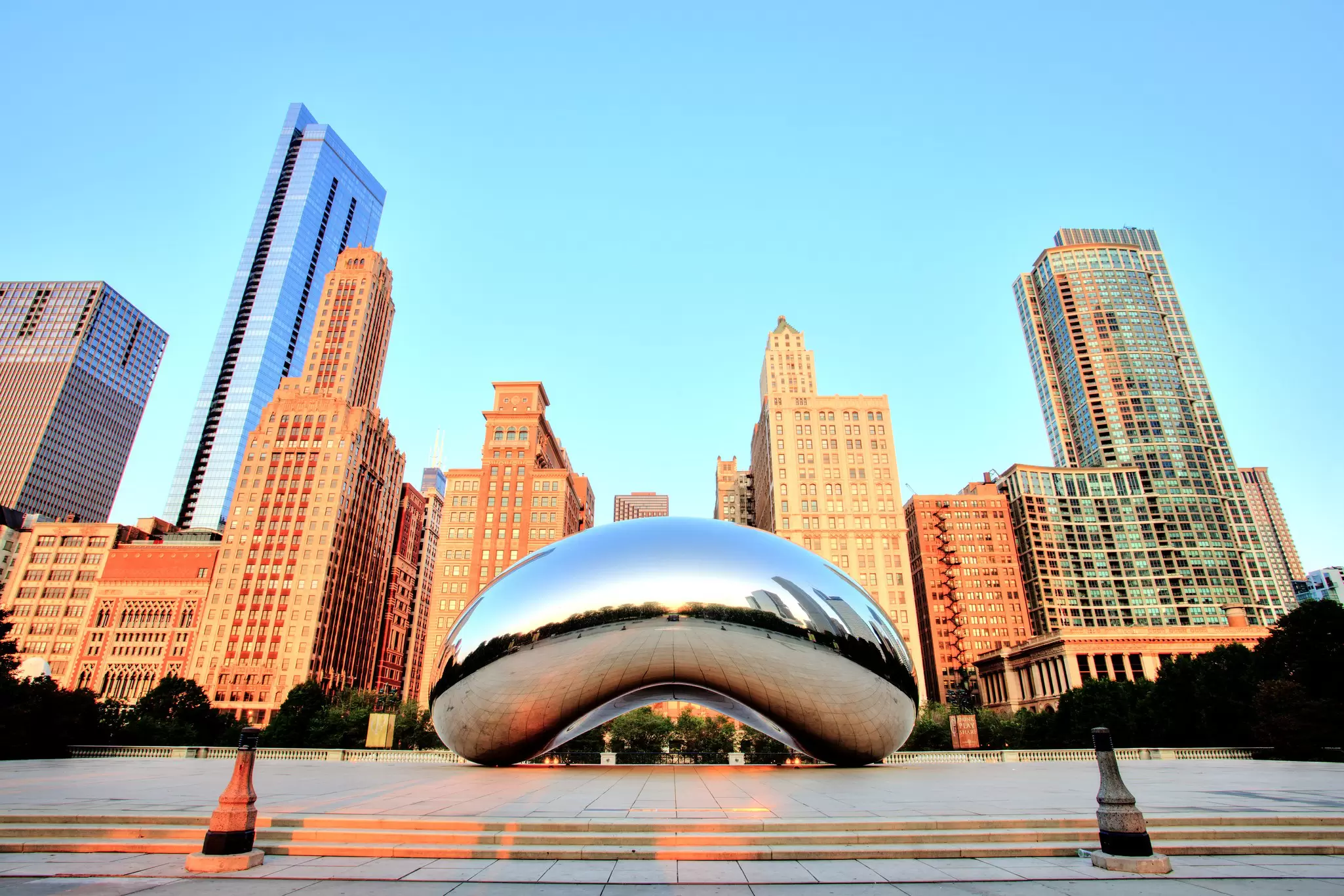 A large freestanding metal sculpture with smooth sides in the middle of a public square
