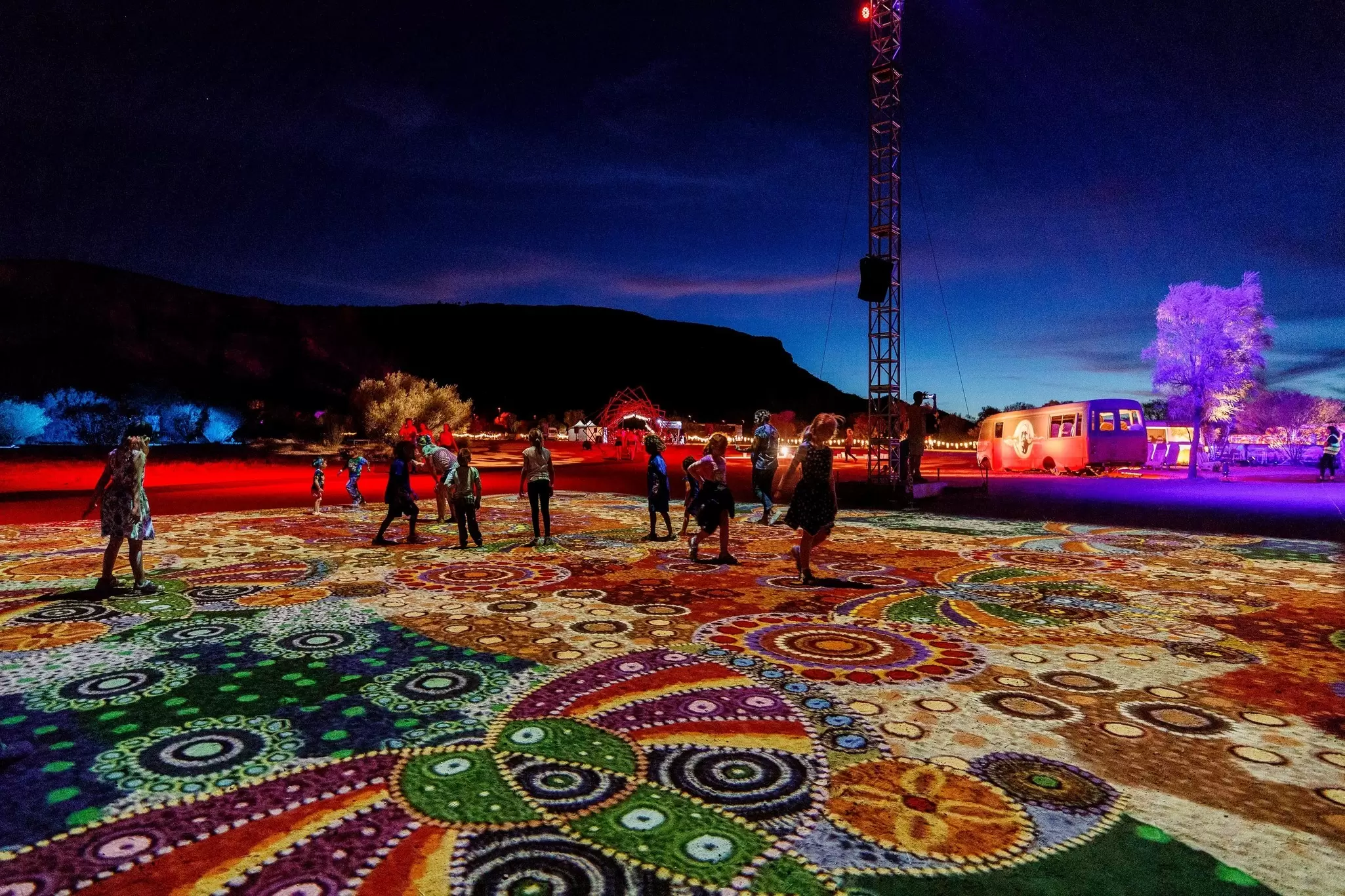 Visitors take in “Grounded” (“Ahelhe Itethe”) by Kathleen Wallace at Parrtjima, the authentic Aboriginal light festival in Alice Springs © courtesy Parrtjima / NTMEC