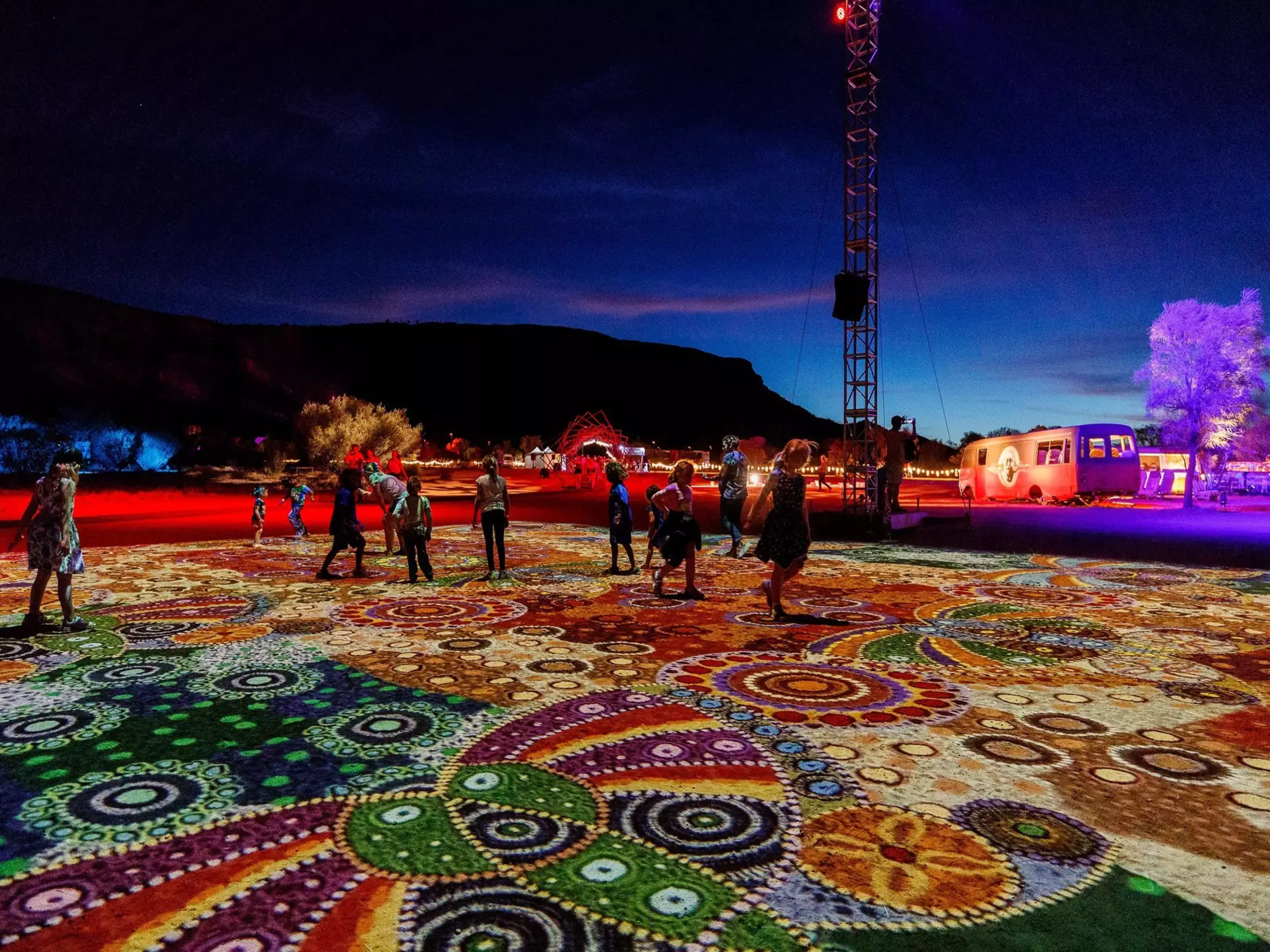 Visitors take in “Grounded” (“Ahelhe Itethe”) by Kathleen Wallace at Parrtjima, the authentic Aboriginal light festival in Alice Springs © courtesy Parrtjima / NTMEC