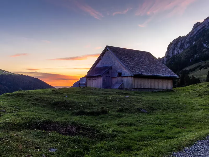 A typical Appenzeller hut on the Alpstein mountain range at sunrise