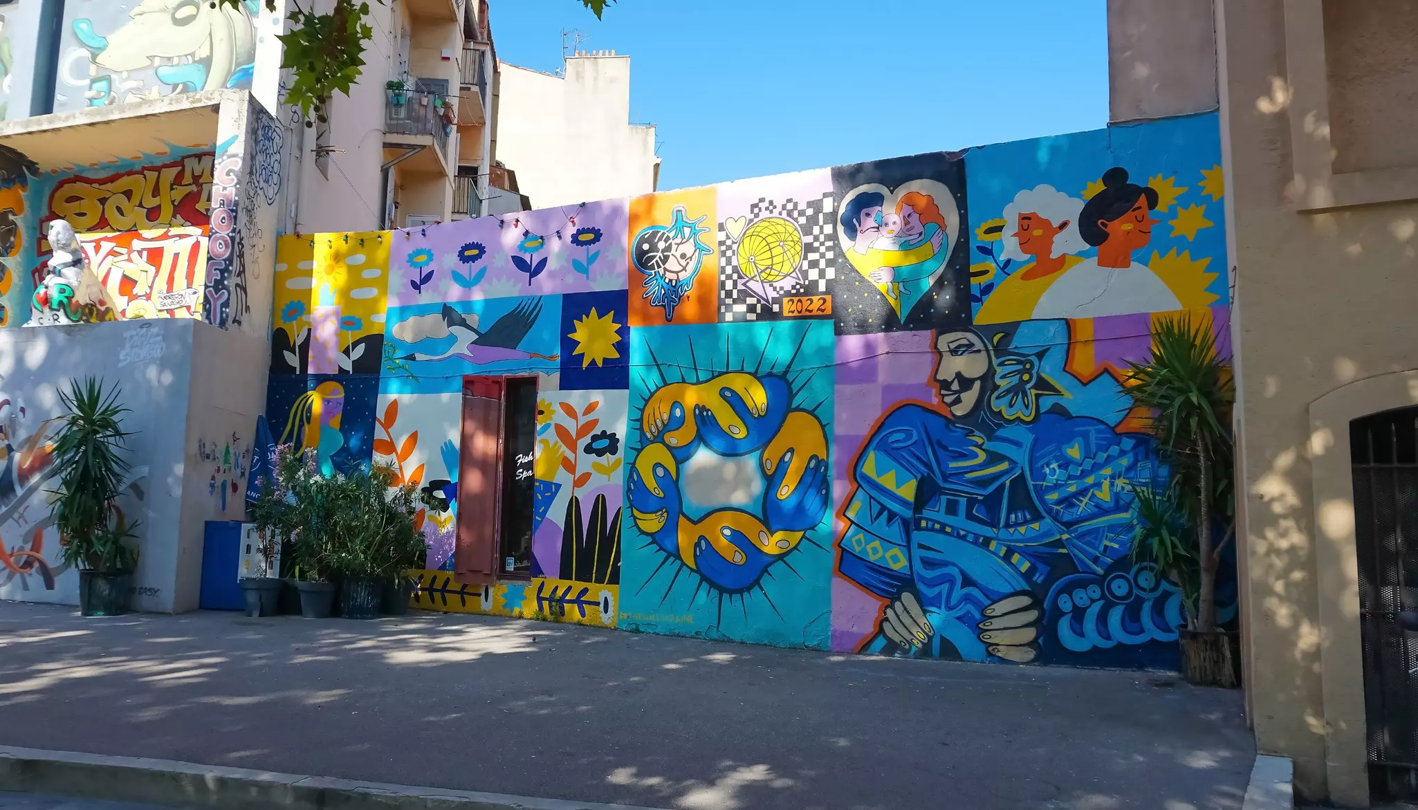 Bright murals on a wall in a street