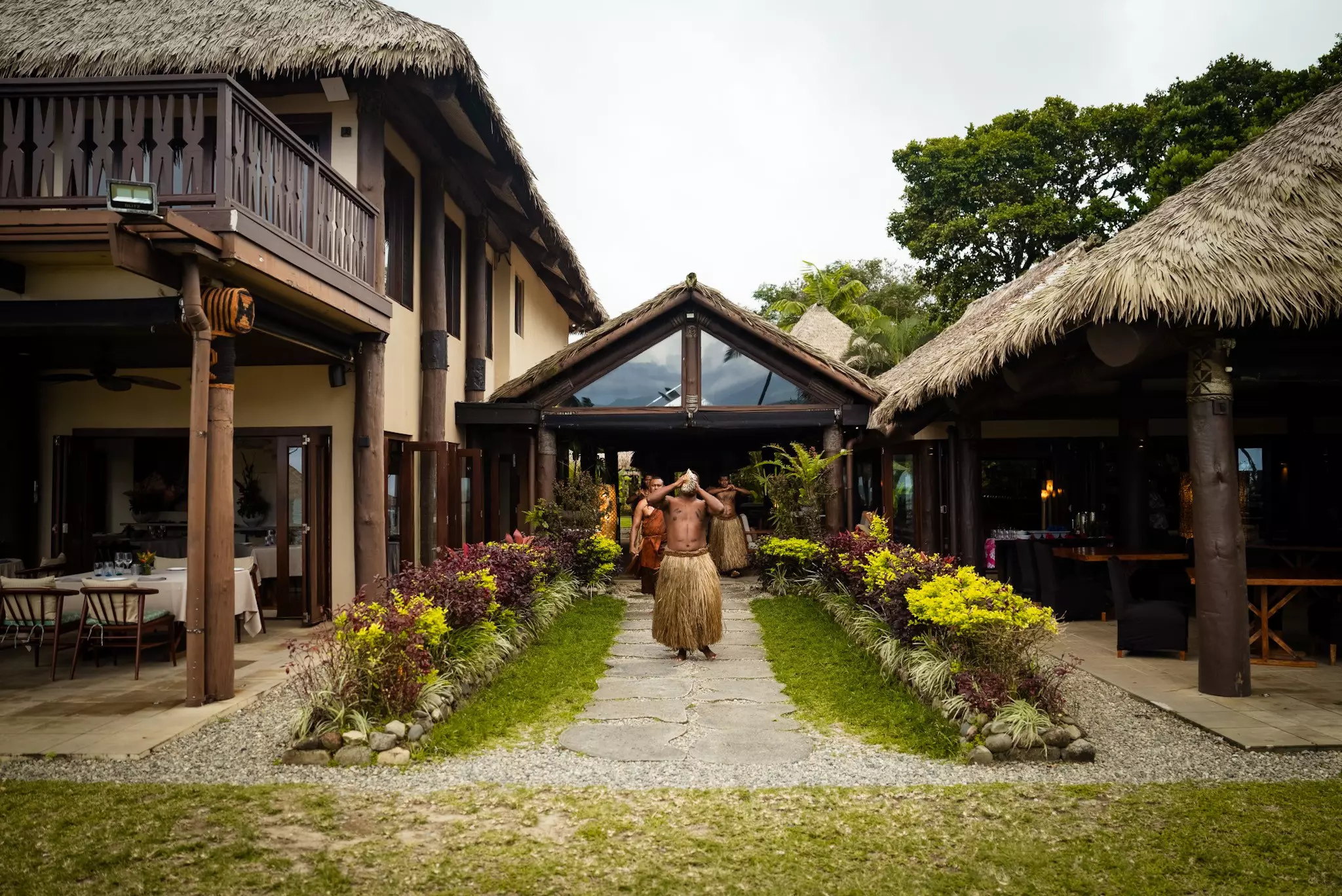 Men in grass skirts standing outside the Nanuku Resort in Fiji