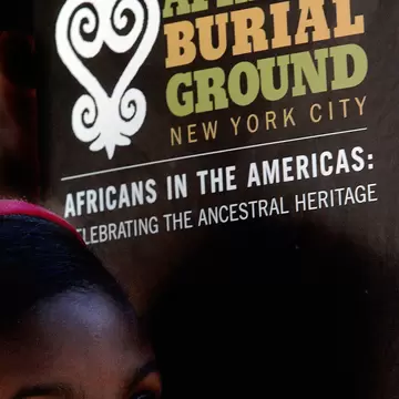 NEW YORK - SEPTEMBER 30: A school child listens to a speaker during a ceremony at the African Burial Ground September 30, 2005 in New York City. Hundreds of school children attended the tribute ceremony at the African Burial Ground, a final restin...