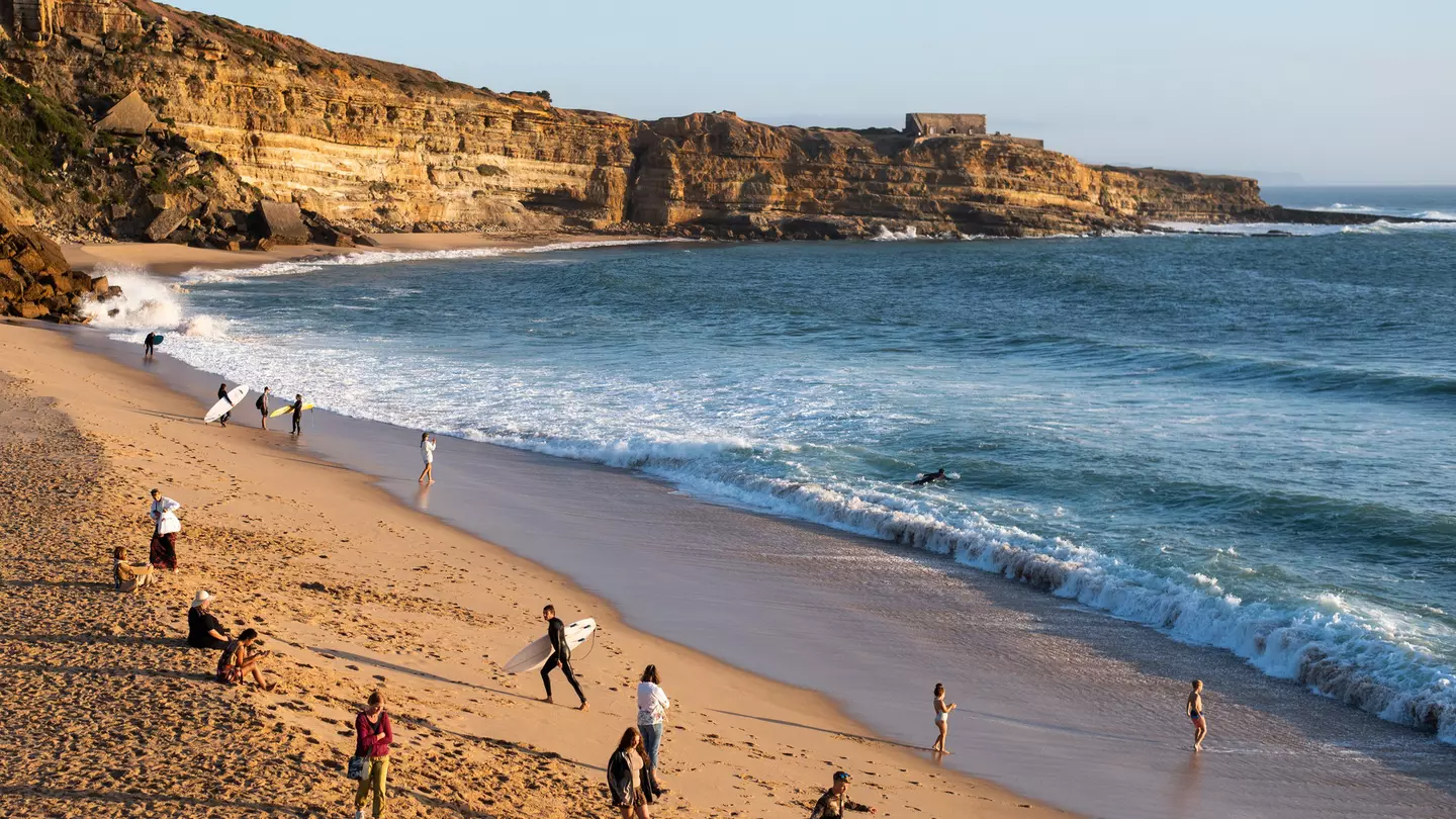 Beachgoers and surfers along Portugal's coast
