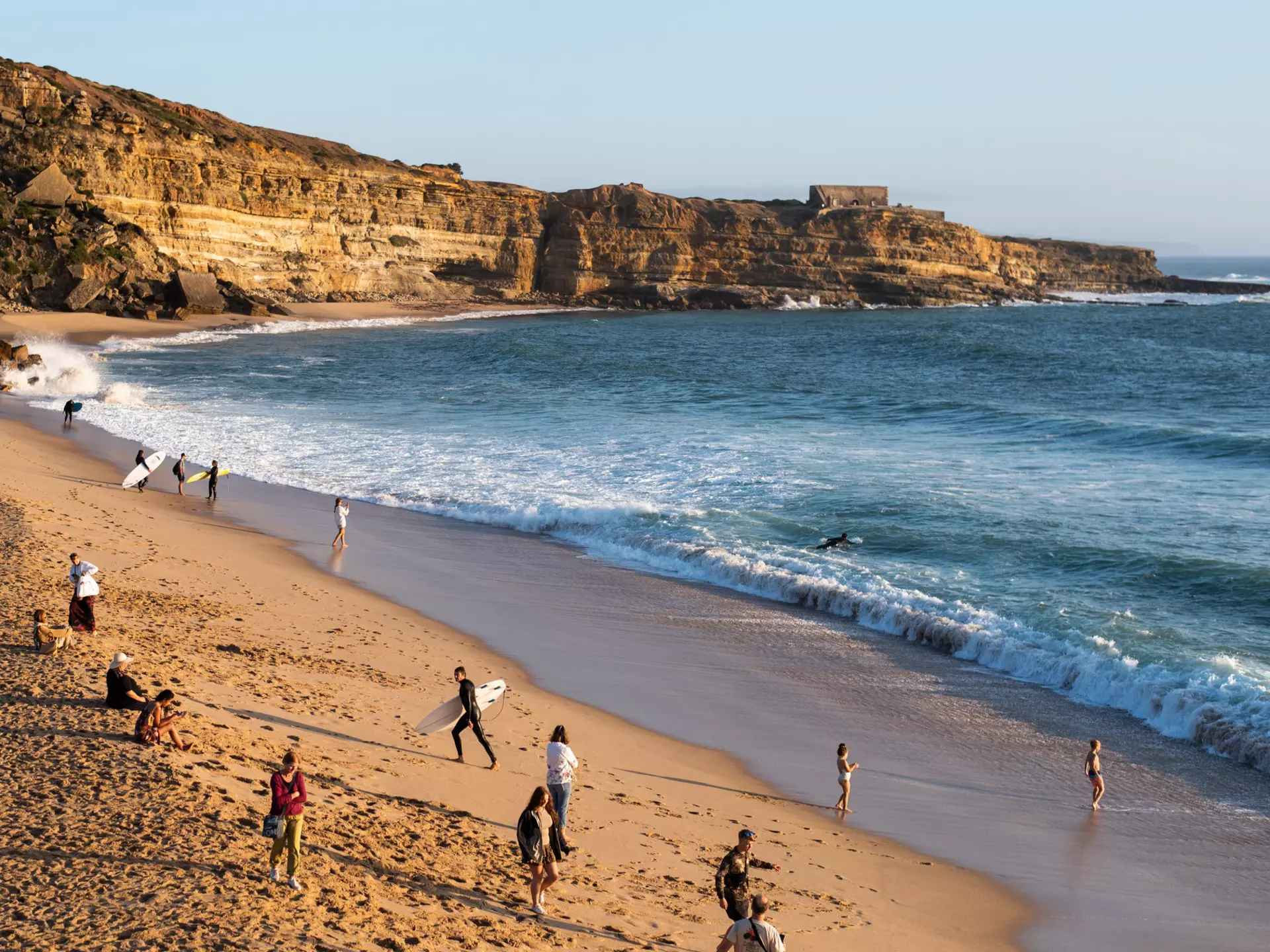 Beachgoers and surfers along Portugal's coast