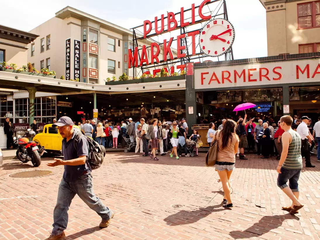 A crowd of people heading in and out of Seattle's Pike Place market.
