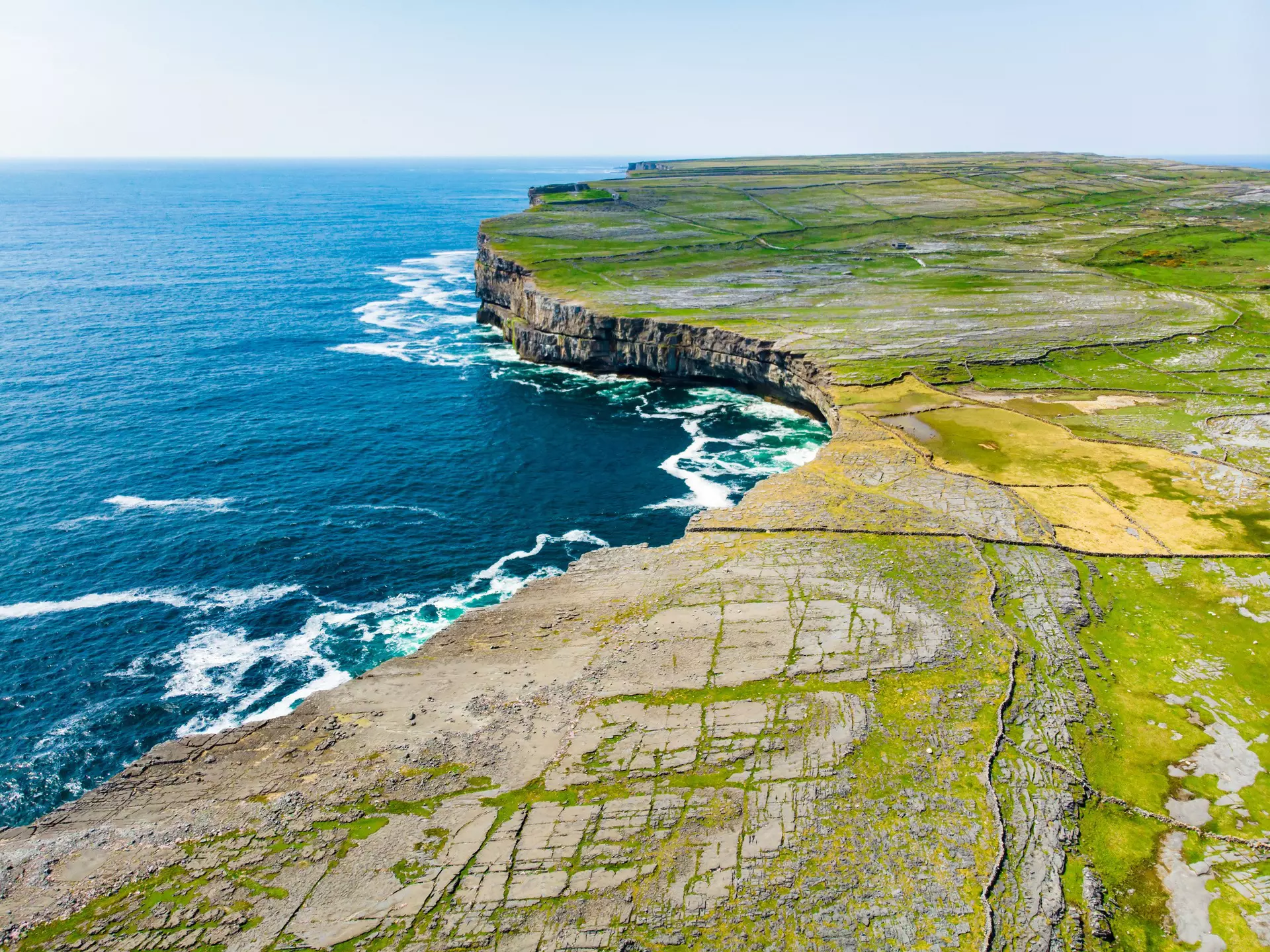 Aerial of the Inishmore (or Inis Mor) coast, the largest of the Aran Islands in Galway Bay.
1470124892
aerial, ancient, aran, architecture, atlantic, attraction, bay, burren, cattle, celtic, cliff, coast, coastline, countryside, culture, destination, dun aengus, dun aonghasa, eire, field, fort, fortress, gaelic, galway, grass, greenery, inishmore, ireland, irish, island, landscape, language, limestone, meadow, monument, neolithic, ocean, pasture, pathway, pavement, prehistoric, rock, ruin, rural, sea, stone, tourism, tourist, travel, wall