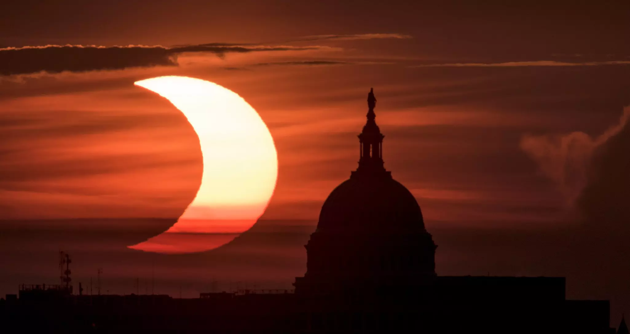 A partial solar eclipse at the United States Capitol building, Thursday, June 10, 2021, as seen from Arlington, Virginia © NASA/Bill Ingalls