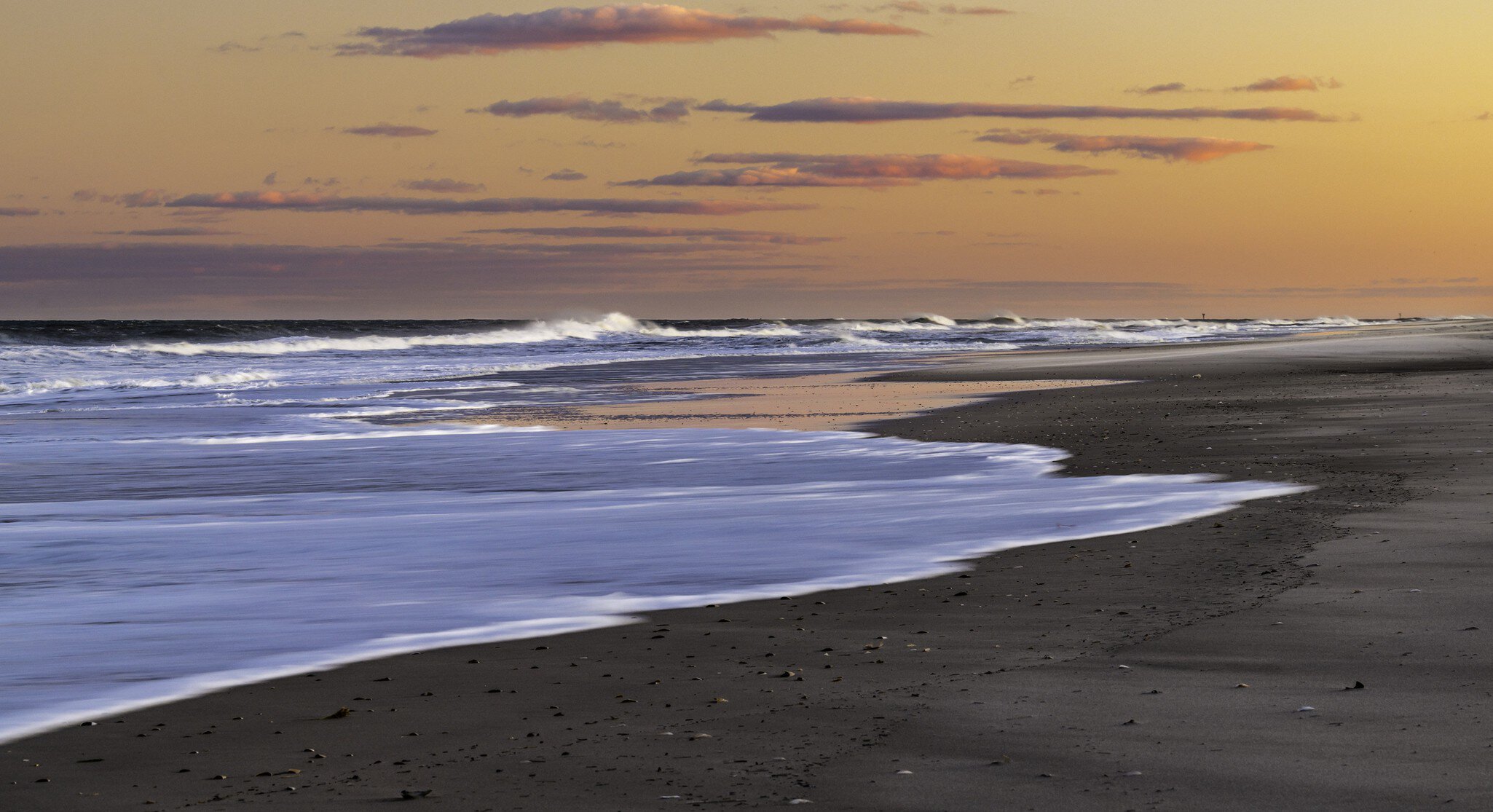 Waves crashing on the shore at Island Beach State Park, New Jersey, at sunset