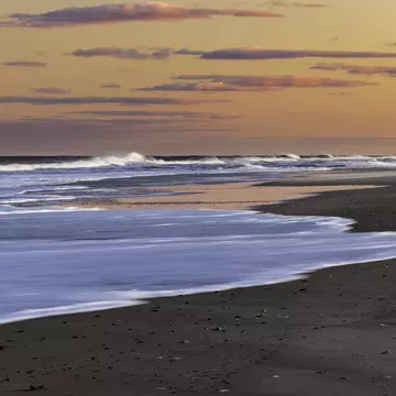 Waves crashing on the shore at Island Beach State Park, New Jersey, at sunset