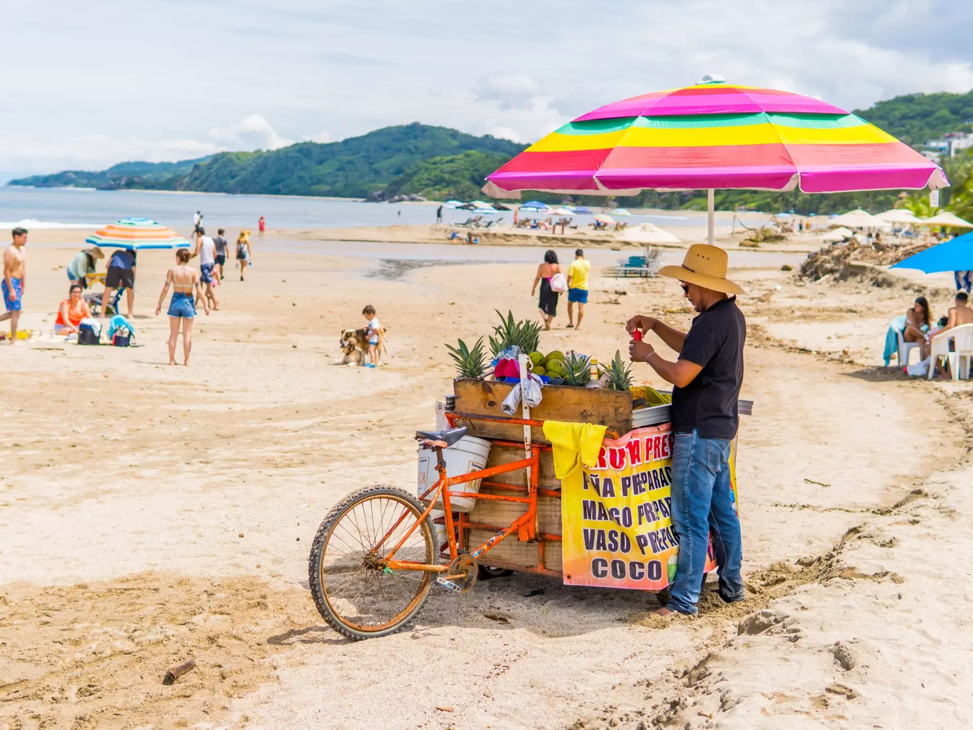 A man sells fruit on the beach in Sayulita. Roaming Pictures/Shutterstock