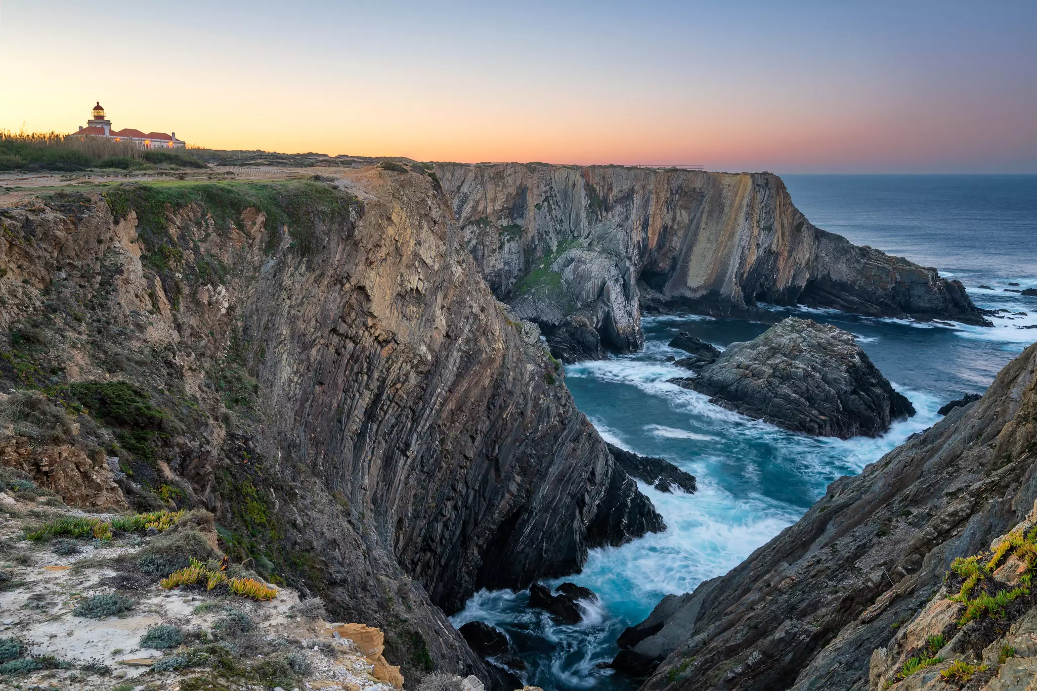 Waves crash below the Cape Sardão lighthouse © Luis Pina Photography / Shutterstock