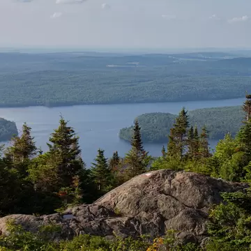 View of Lake Stukely surrounded by forest in Parc National du Mont Orford, Canada.