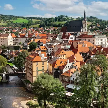 A historic town with red roofs and a large cathedral.