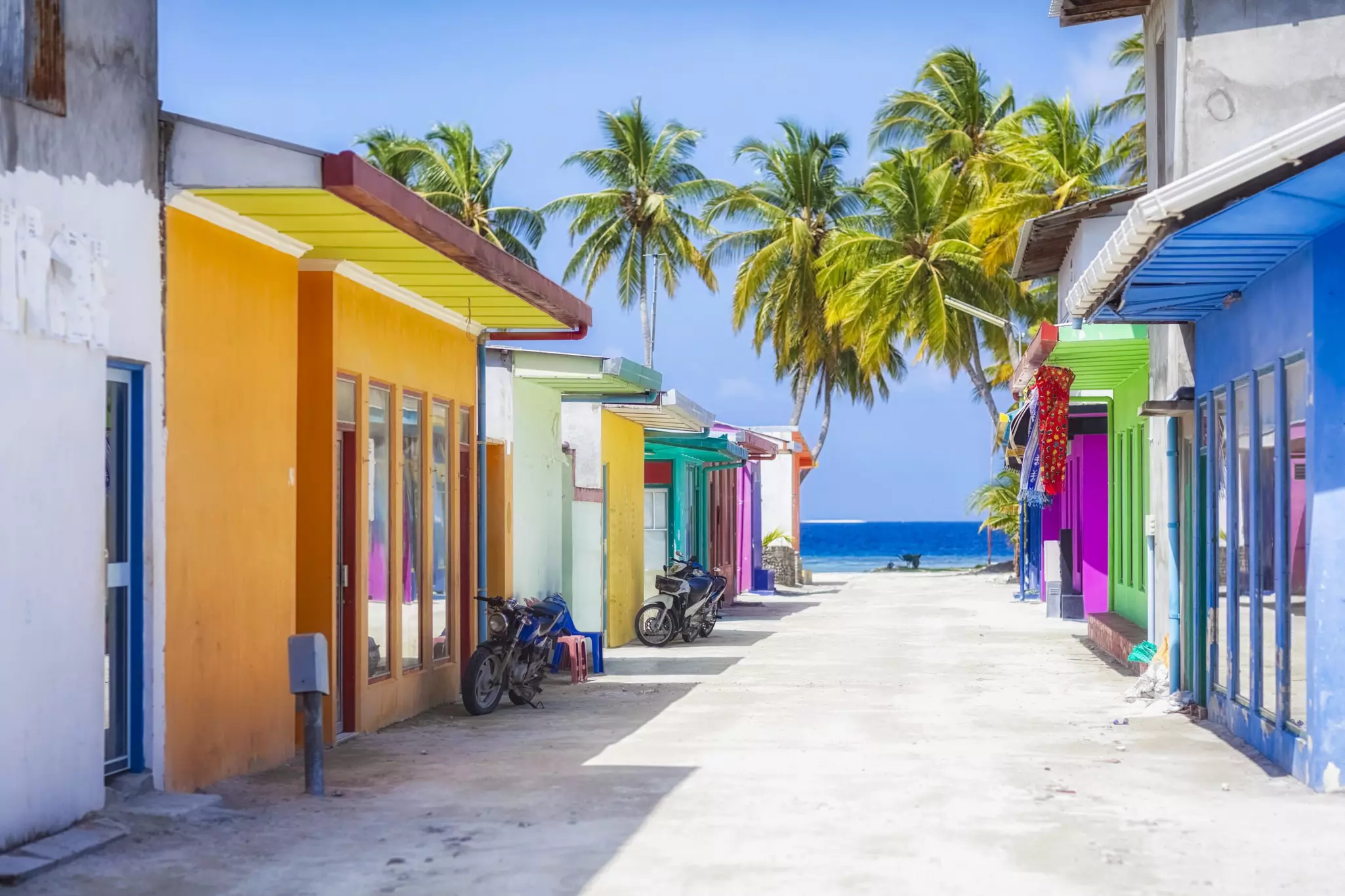 Brightly covered homes on a street in the Maldives.