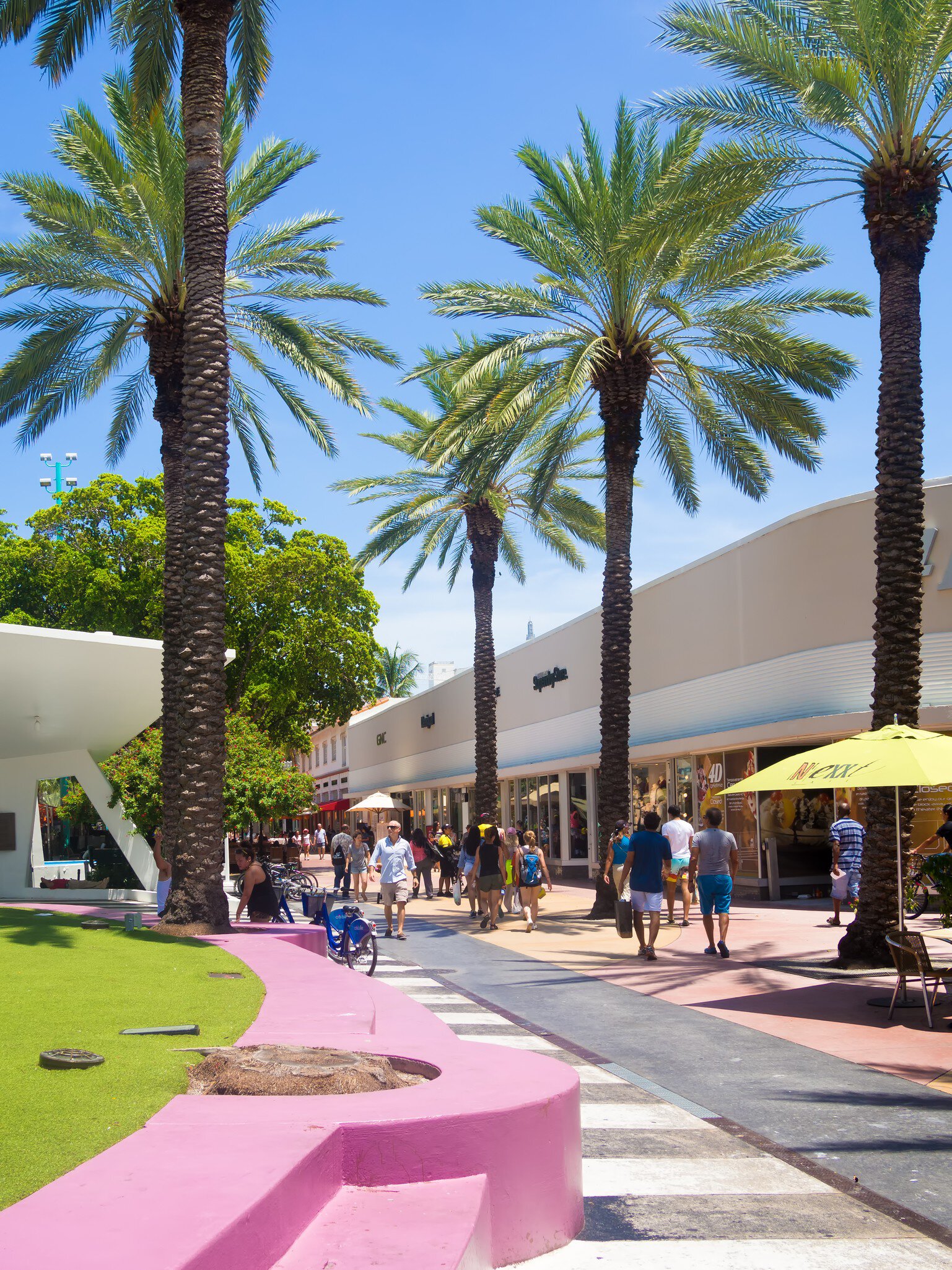People walk down Lincoln Road, a famous shopping boulevard in Miami Beach, Florida.