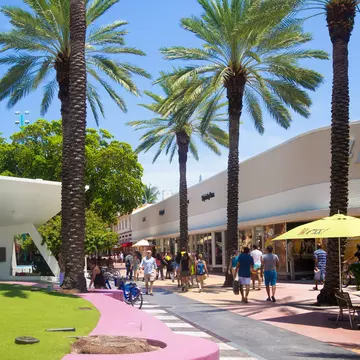 People walk down Lincoln Road, a famous shopping boulevard in Miami Beach, Florida.