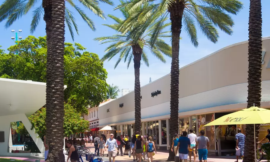 People walk down Lincoln Road, a famous shopping boulevard in Miami Beach, Florida.