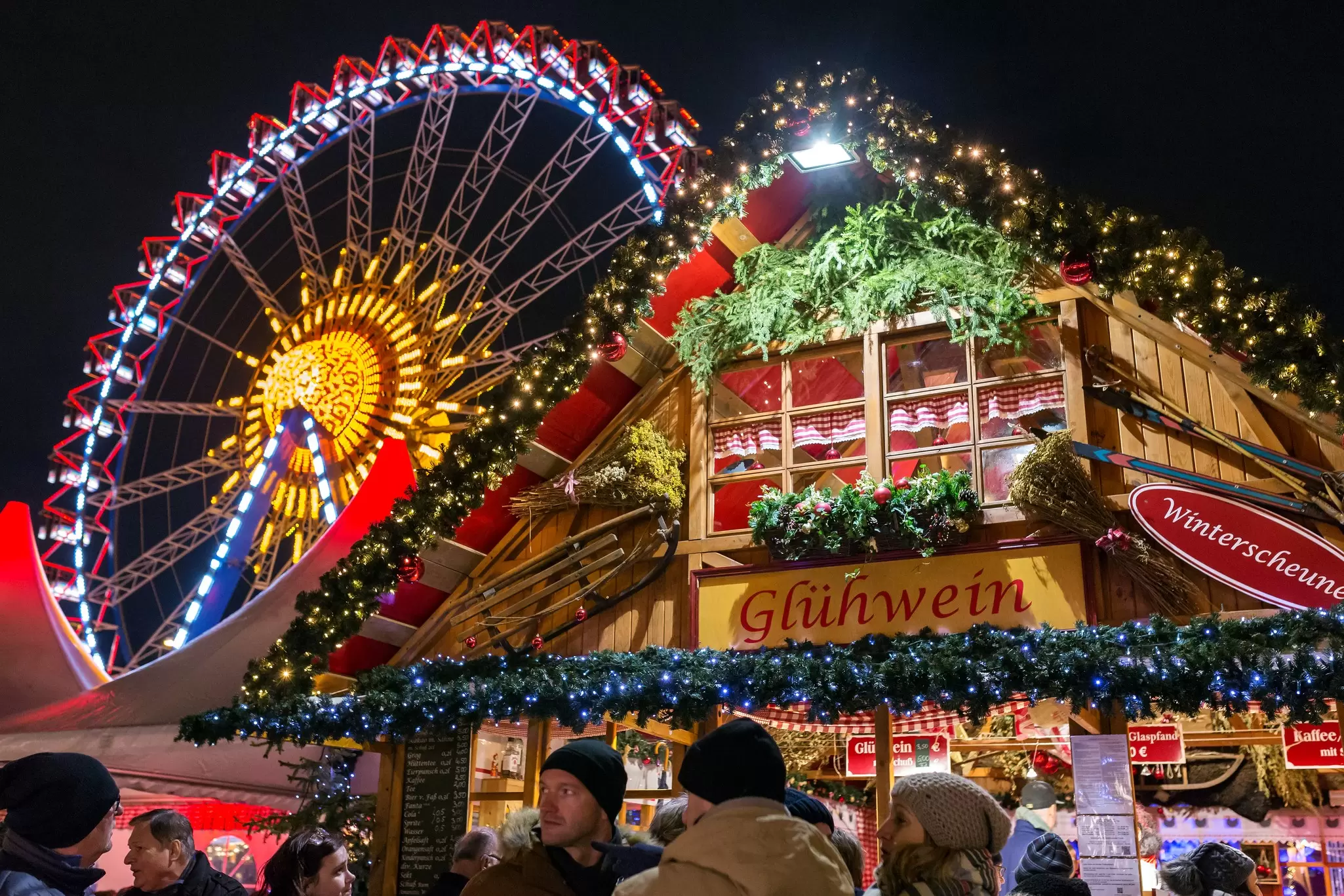 Ferris wheel and stalls at Christmas market on Alexanderplatz in Berlin, Germany
