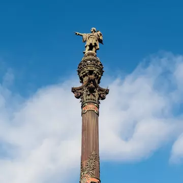 View of the Mirador de Colom (Columbus Monument) on a sunny day in Barcelona, Spain.