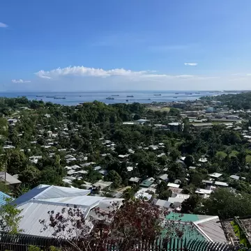 A small low-rise town spreads out on the land towards the coast