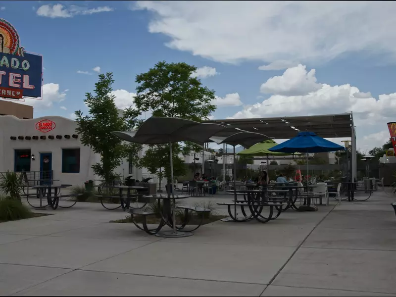 El Vado Motel's courtyard featuring umbrella-topped dining tables